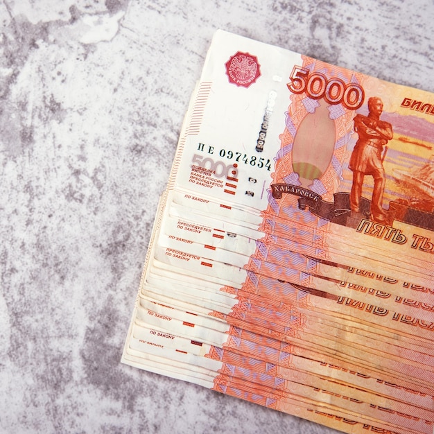 Photo russian cash banknotes in denominations of five thousand rubles the bundle lies on a gray background