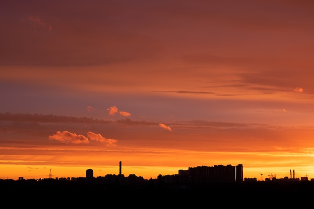 russian city at sunset with buildings and colorful sky.