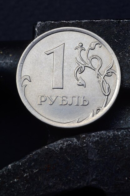 Russian coin denominated 1 ruble shines on a scratched metal surface closeup translation of the text on the coin quot1 rublequot