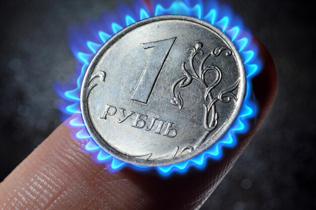 Russian coin in denomination of one rublexAlies on the finger closeup photomontage burning coin