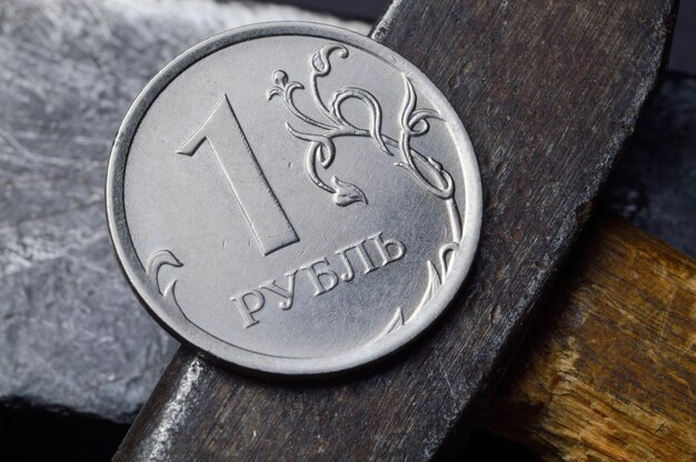 Russian coin with a face value of 1 ruble and an old working tool closeup translation of the text on the coin quot1 rublequot