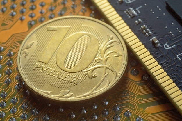 Russian coin with a face value of 10 rubles lies among the microcircuits a concept illustrating the pricing of electronics in Russia