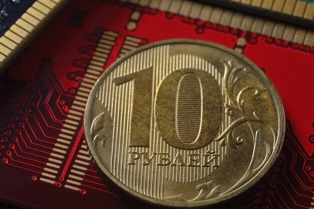 Russian coin with a face value of 10 rubles lies among the microcircuits a concept illustrating the pricing of electronics in Russia