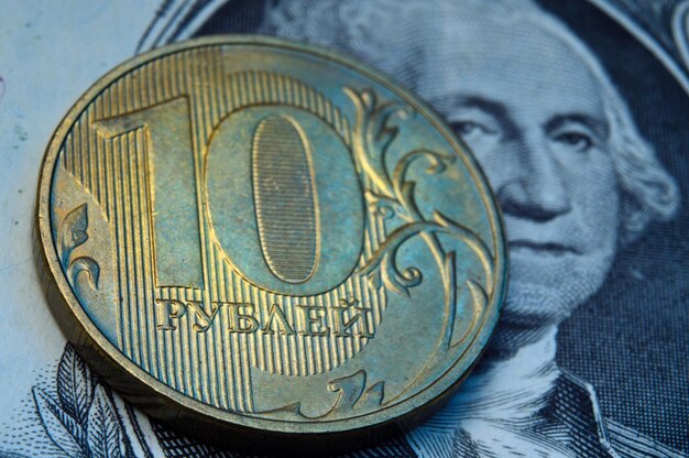 Russian coins of 10 rubles face value lie on the American paper dollar