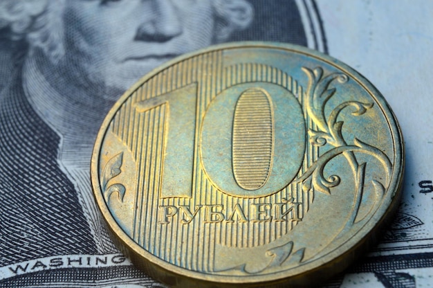 Russian coins of 10 rubles face value lie on the American paper dollar