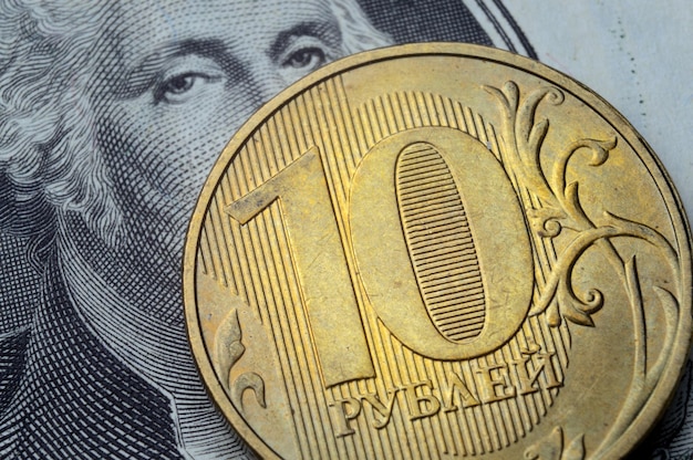 Russian coins of 10 rubles face value lie on the American paper dollar