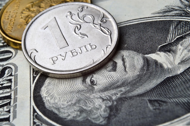 Russian coins of 10 rubles face value lie on the American paper dollar