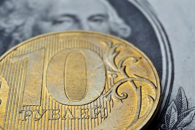 Russian coins of 10 rubles face value lie on the American paper dollar