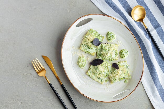 Russian dumpling served with parsley and cheese on plate close up