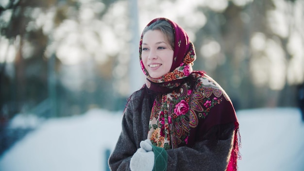 Russian folklore  russian woman in a scarf is clapping her hands and smiling