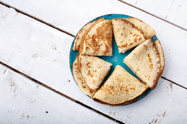 Russian Fried pancakes on old wooden table. Top view. Flat lay. Star shape.