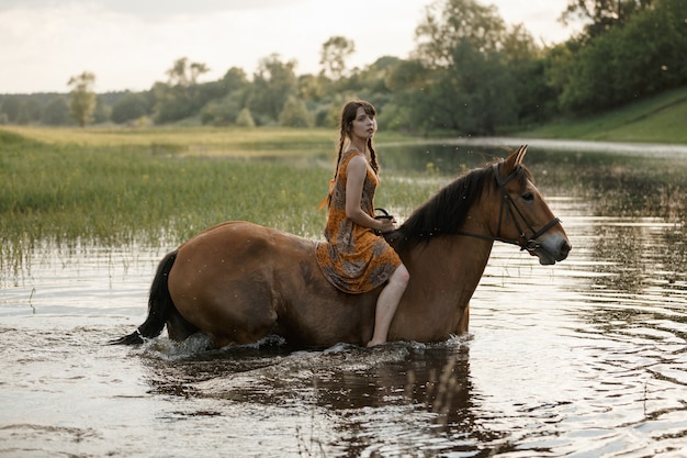 Russian girl on a horse, spring nature, man and animal