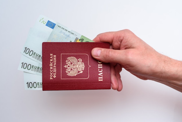 Russian international passport with euro in the man's hand