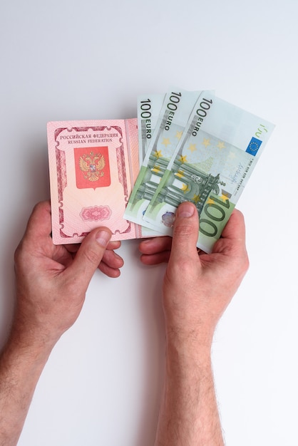 Russian international passport with euro in the man's hand