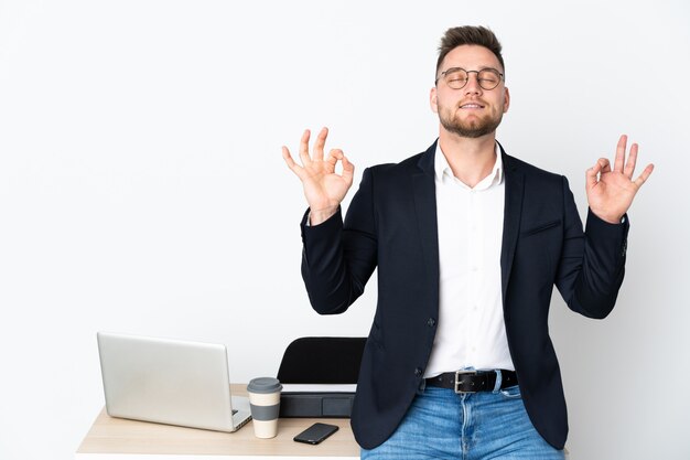 Russian man in a office on white wall in zen pose