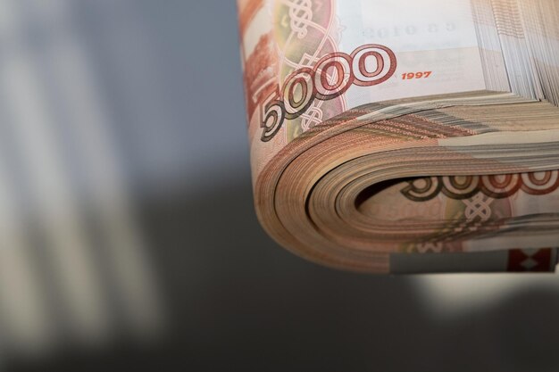 Russian money rubles Five thousandth banknotes cash A stack of money in a female hand with a French manicure