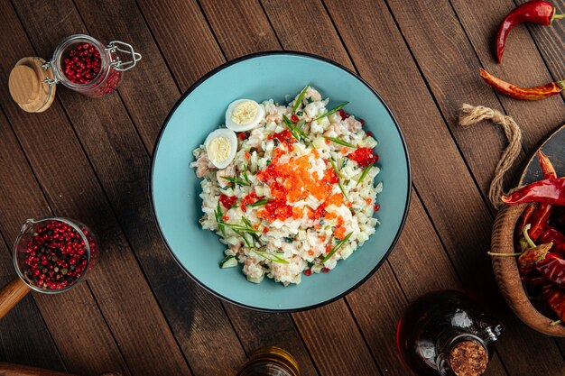 Russian olivier salad with salmon and caviar