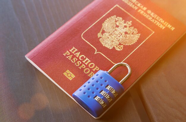 Photo russian passport locked to padlock. symbol of anti-russian sanctions