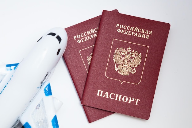 Russian passport on a white background and plane