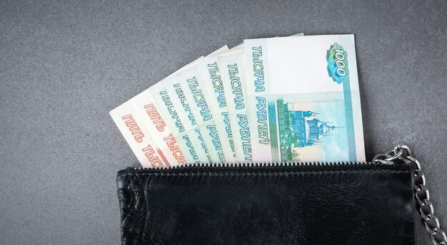 Russian rouble bills in black old leather wallet