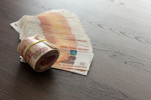 Russian rubles cash is lying 5000 rubles The money is rolled up and tied with an elastic band