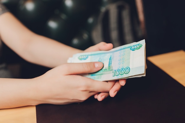 Russian rubles in the hand of a fan.male hand holding many of the Russian banknotes.The transfer of money.