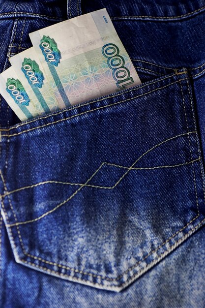 Russian rubles stick out of a hippocket jeans