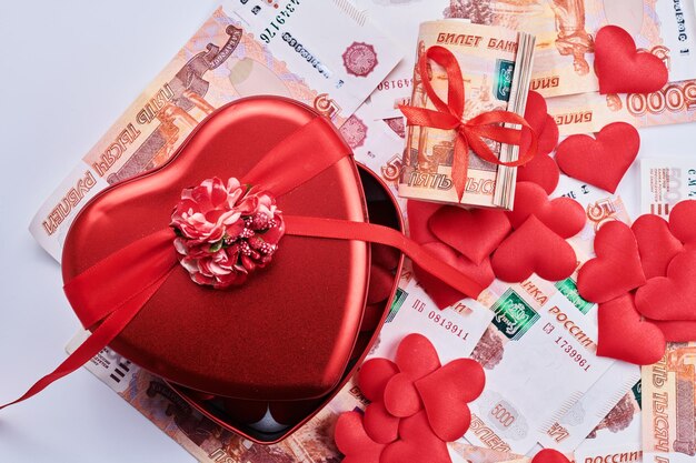 russian rubles on white background bundle of five thousand banknotes with red ribbon in heart box money gift concept