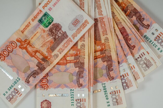 Russian rubles with a face value of 5000 on the table in close-up.