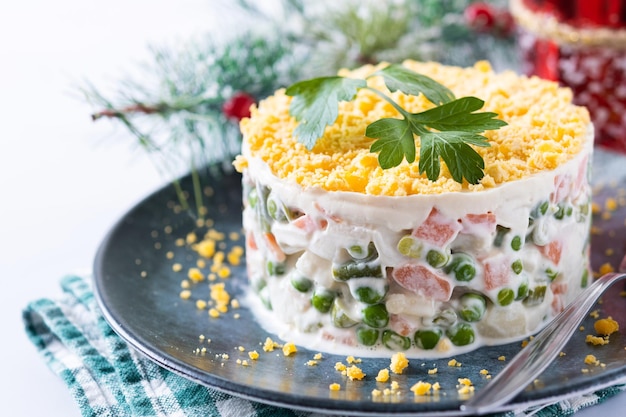 Russian salad or Olivier salad for Christmas dinner on marble background