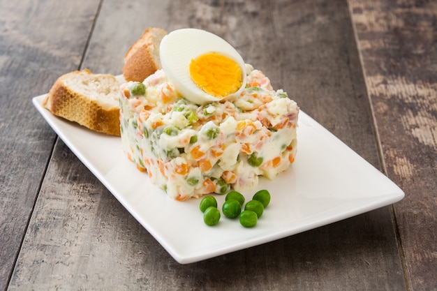 Russian salad on a rustic wooden table