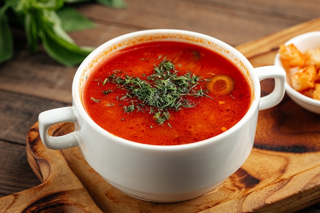 Russian soup solyanka with smoked meats