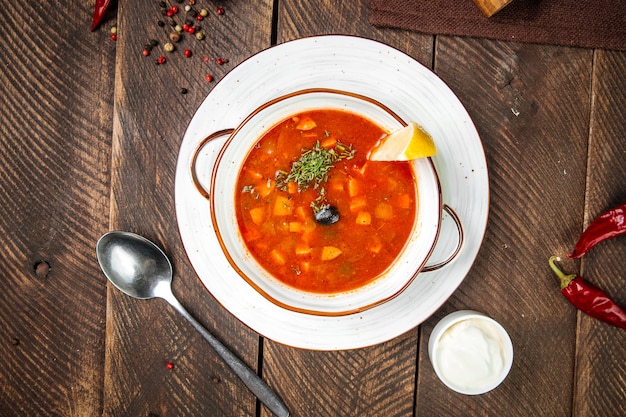 Russian soup with smoked meat on the wooden table