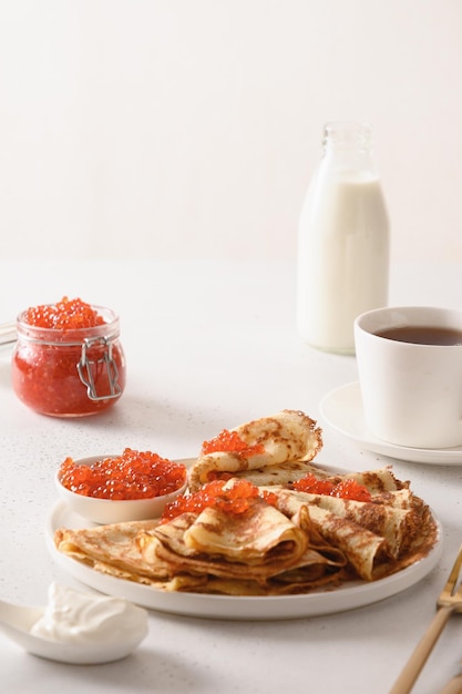 Russian thin pancakes or blini with red caviar