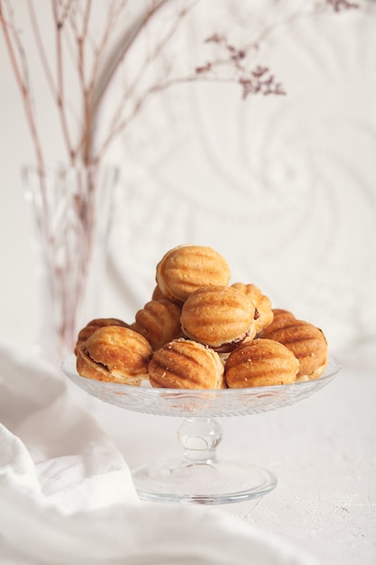 Russian traditional homemade cookies Nuts with condensed milk on a glass stand.