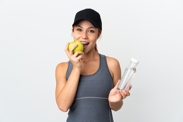 Russian woman isolated on white with a bottle of water and eating an apple