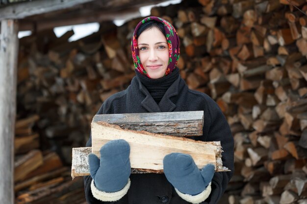 Russian woman in Winter Clothes with firewood