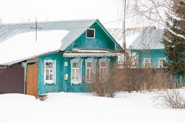 A russian wood house covered in snow