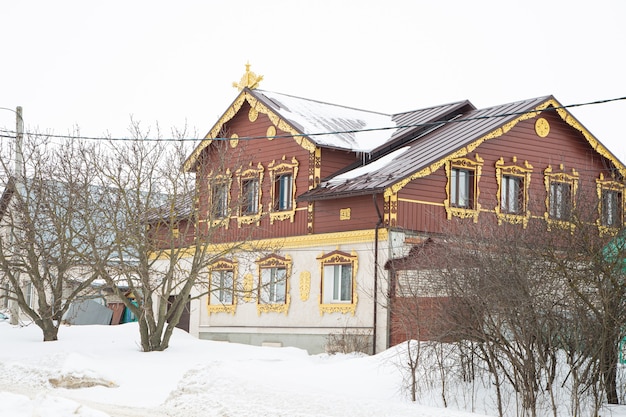 A russian wood house covered in snow