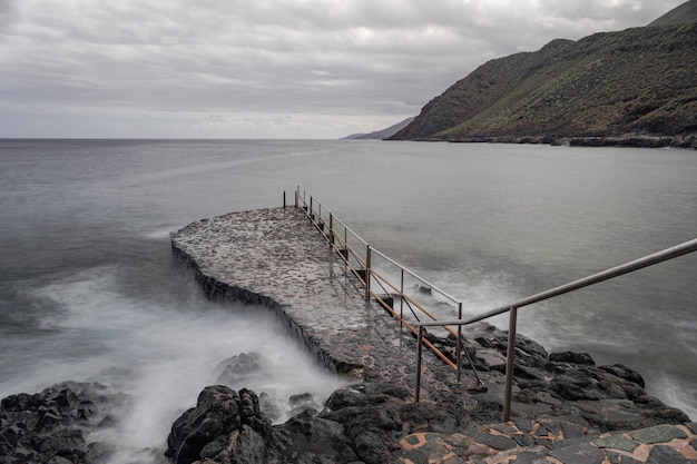 rusted metal ladder, on rock platform,  La Caleta, El Hierro, Canary islands, Spain