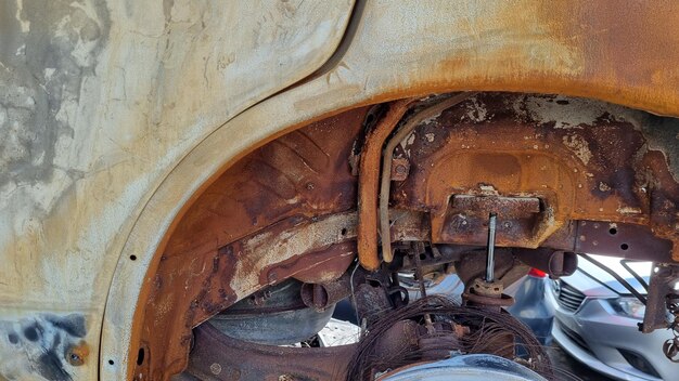 A rusted vehicle with a rusted bumper.