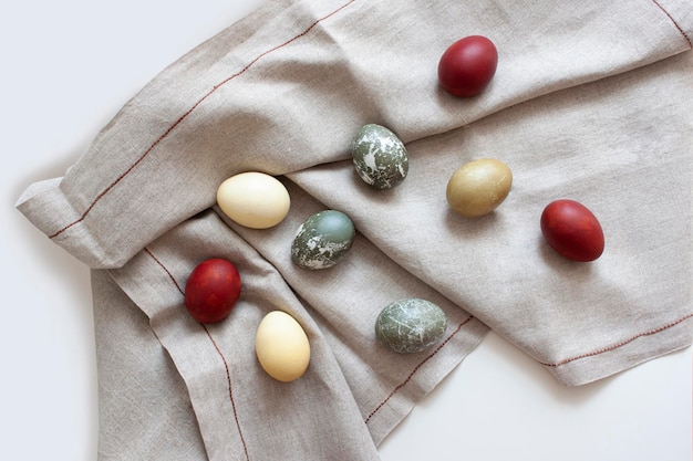 Rustic background Colored eggs on a woven fabric Easter background