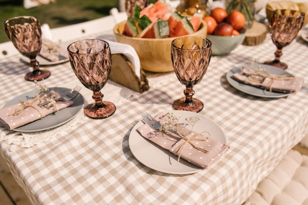 Rustic birthday decor on the street table setting with fruits beautiful dishes and flowers