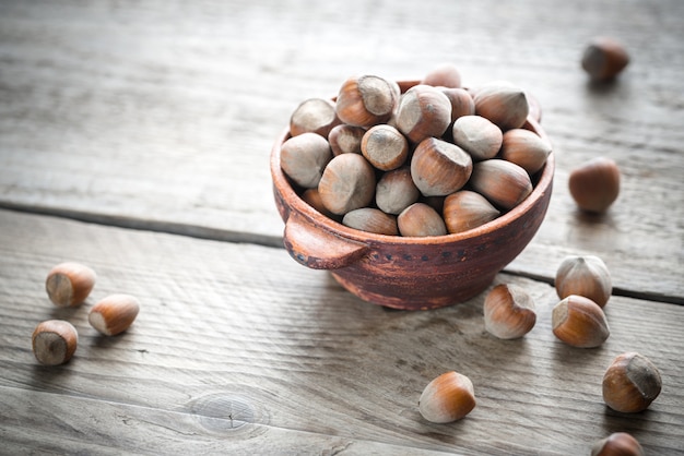 Rustic bowl of hazelnuts on the wooden table