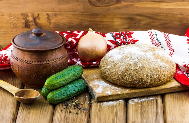 Rustic bread with cucumbers on a wooden table