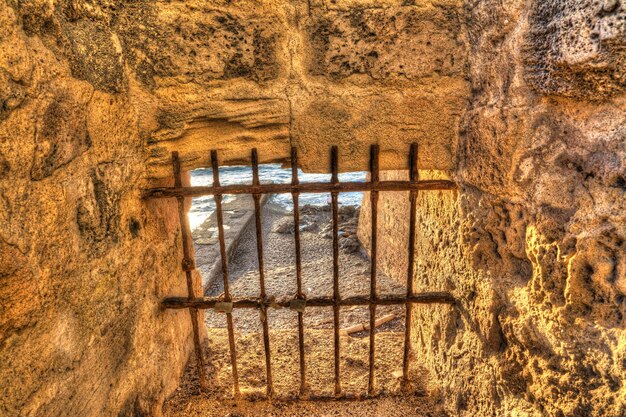 Rustic cage with metal grill by the sea Processed for hdr tone mapping effect