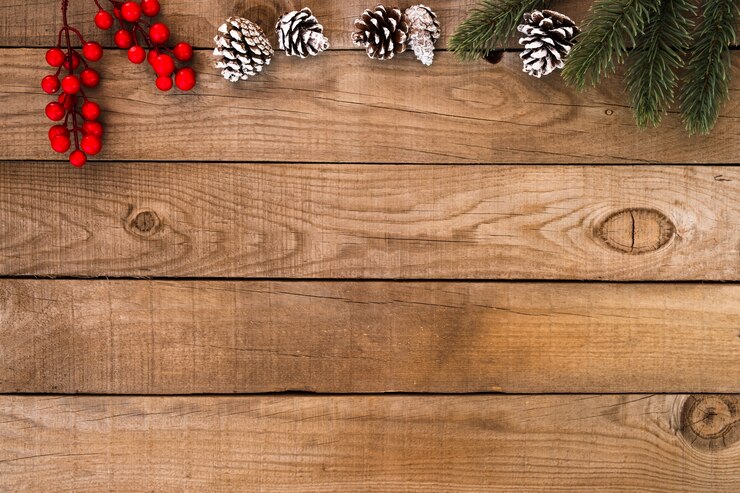 Photo rustic christmas background, xmas ornament with fir and holly berry on wood. vintage style, top view.