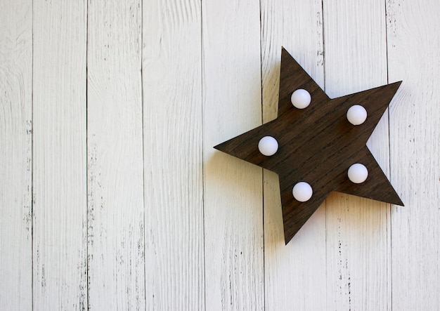 Rustic Christmas decorations and string lights on a wood style background