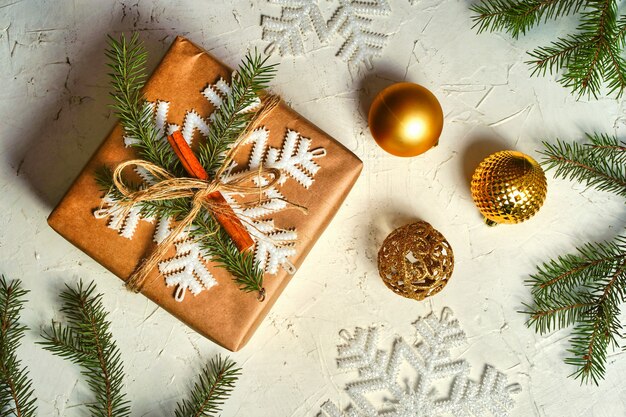 Rustic christmas gift box with christmas decorations on white background flat lay new year present