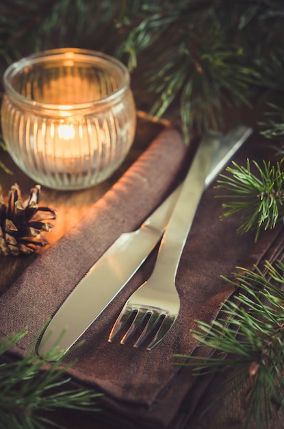 Rustic Christmas table setting with candle.